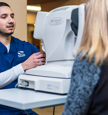 Eye Tech gives patient an eye exam