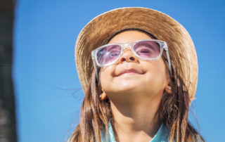 Image of sunglasses protecting a child from UV rays
