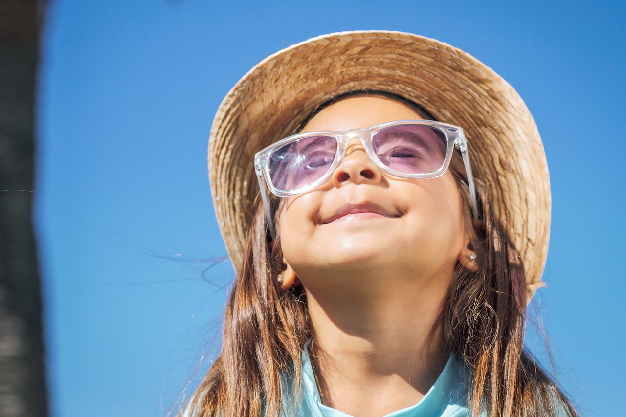 Image of sunglasses protecting a child from UV rays