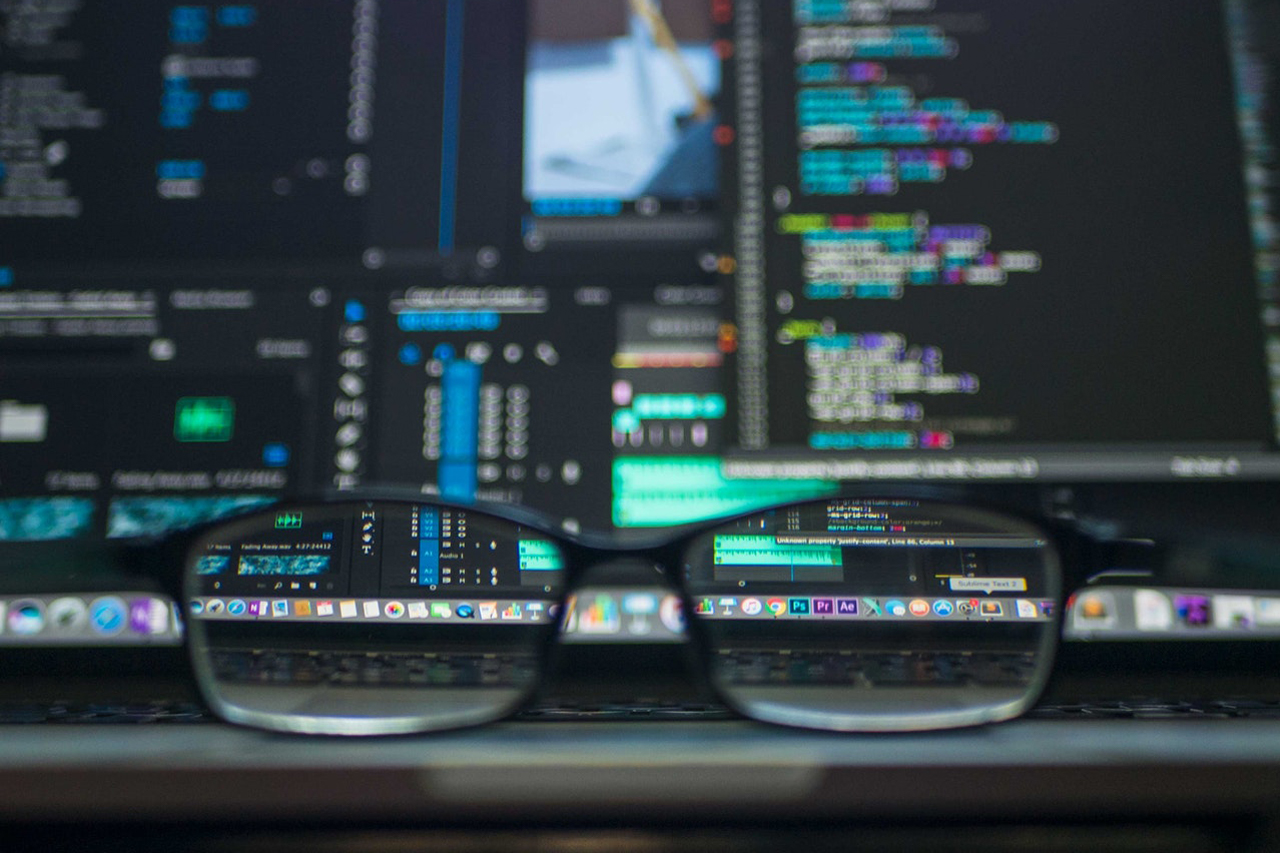 image of glasses in front of a computer screen