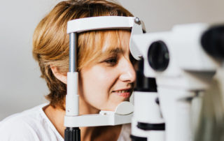 Image of woman receiving an eye exam for blurry vision