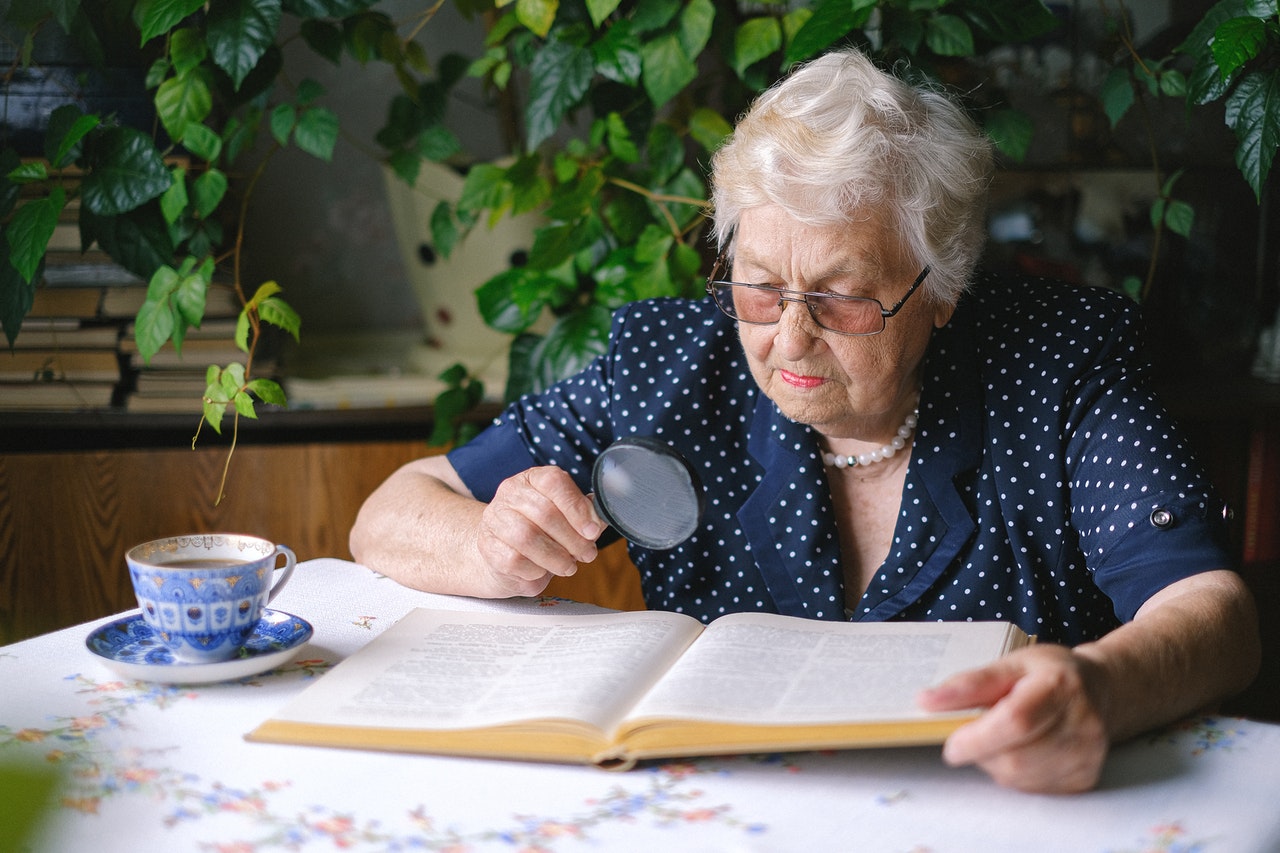 image of old woman reading a book