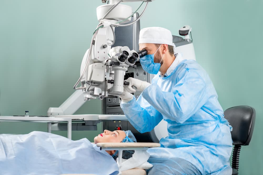 surgeon looking into the microscope