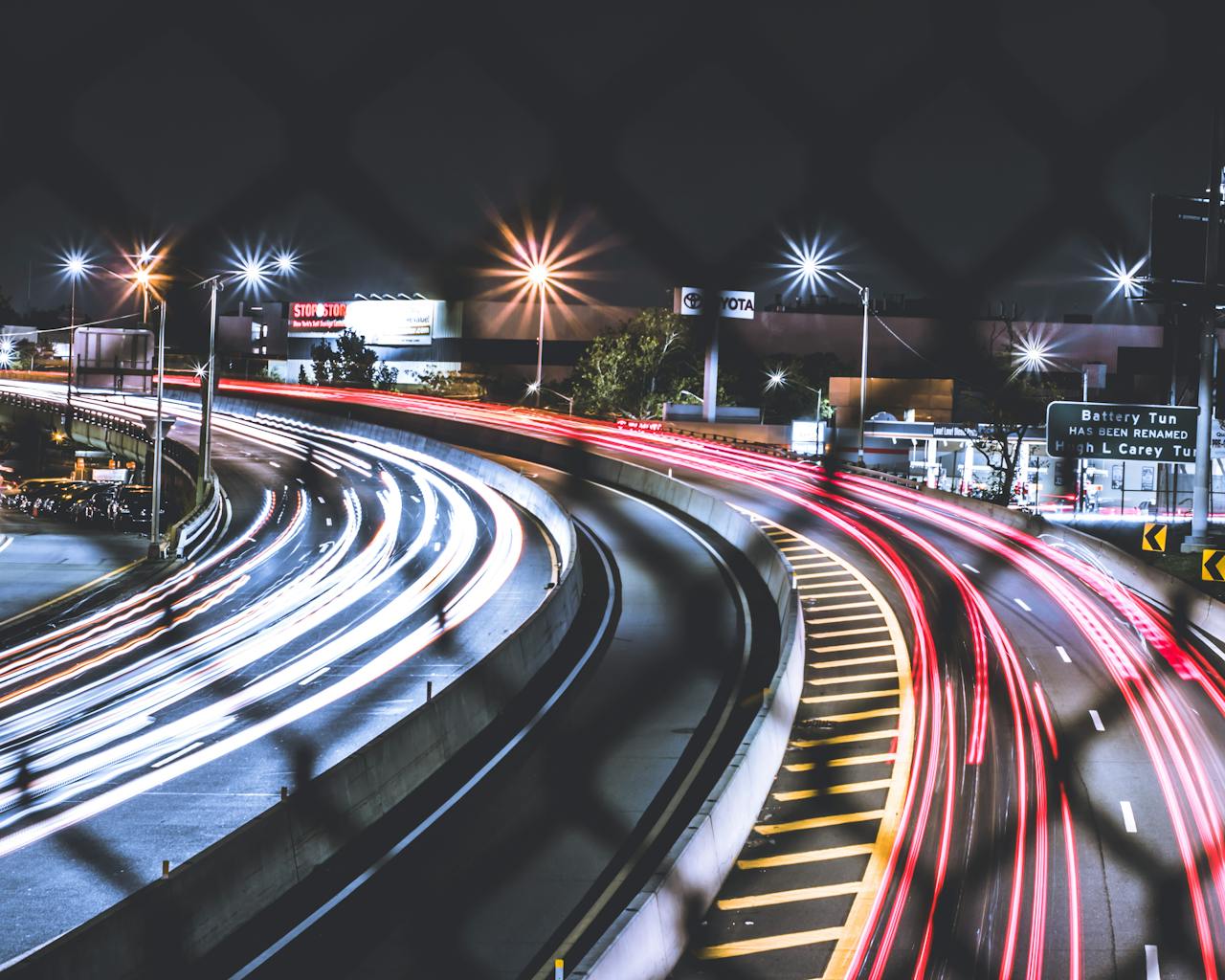 Driving on a freeway at night with lights and glare
