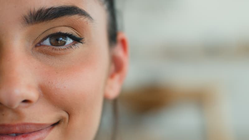 Half face portrait Indian woman smiling looking at camera